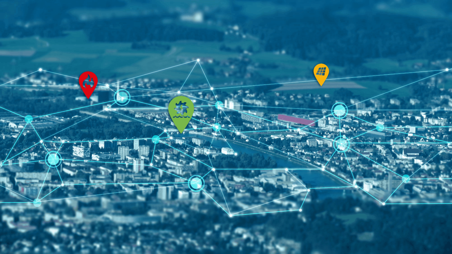 © RSA iSpace Netzwerk aus blauen Linien mit drei Pins in grün (Zahnard), gelb (PV-Anlage) und rot (Flamme) vor dem Hintergrund einer leicht verschwommenen Darstellung einer Stadt aus der Vogelperspektive