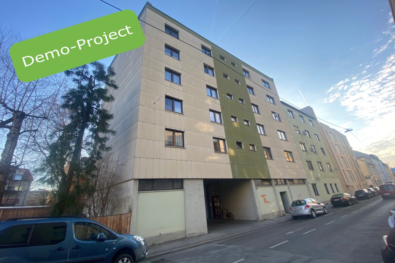 Photo of a multi-storey residential building with indication "Demo-Project"