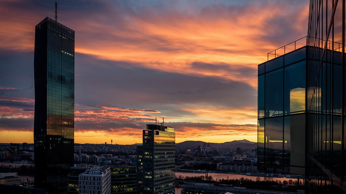 Blick auf eine Stadt mit Fluss bei Sonnenuntergang, von einem hohen Gebäude aus aufgenommen