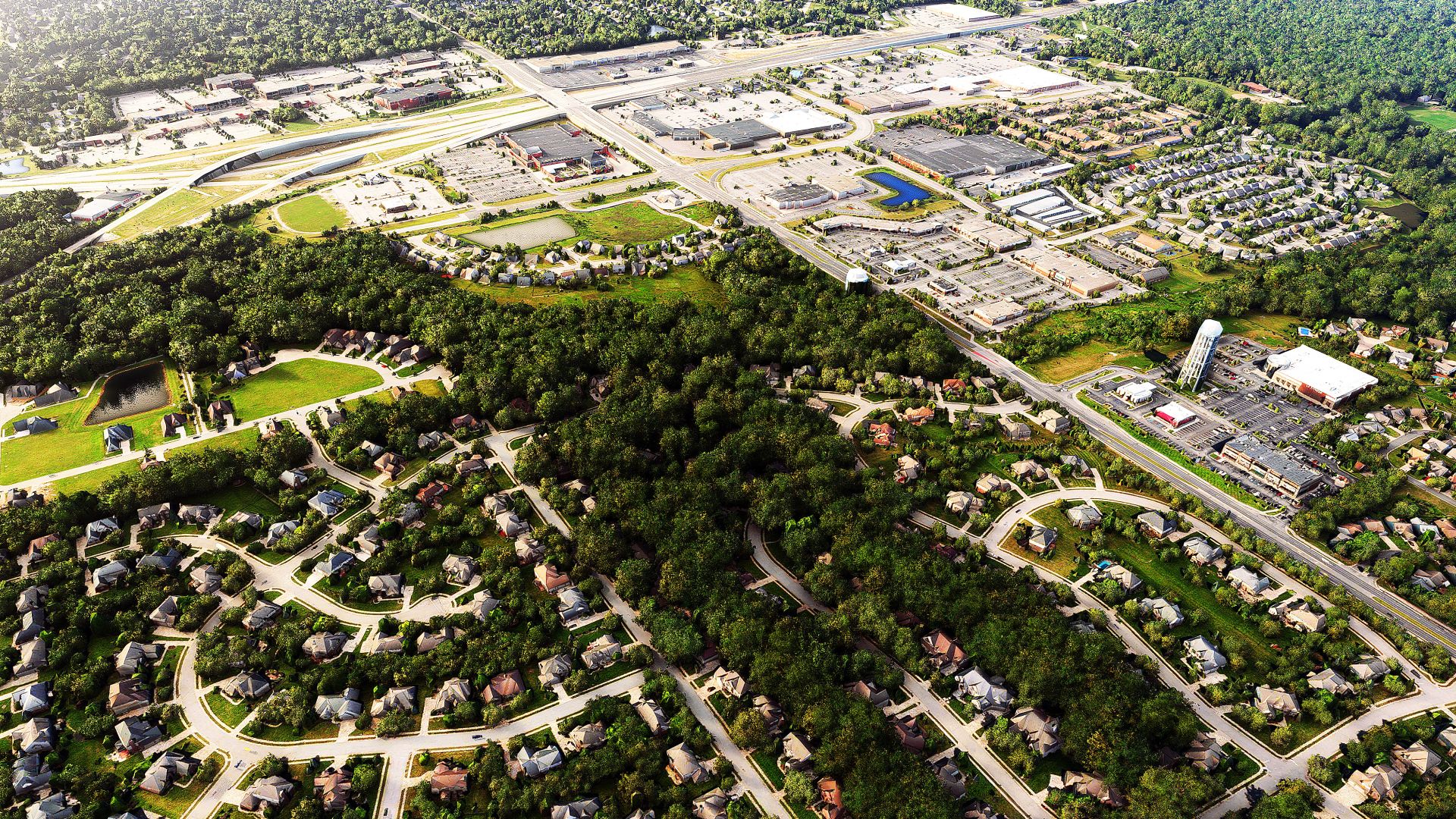 Ein Siedlungsgebiet neben einem Industriegebiet aus der Vogelperspektive